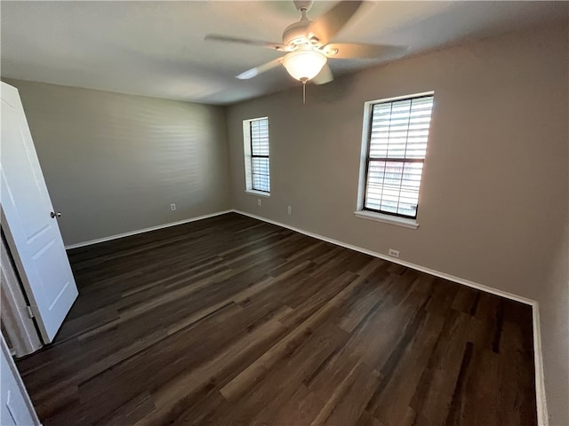 unfurnished room featuring ceiling fan and dark hardwood / wood-style flooring