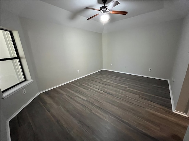 unfurnished room with ceiling fan and dark wood-type flooring