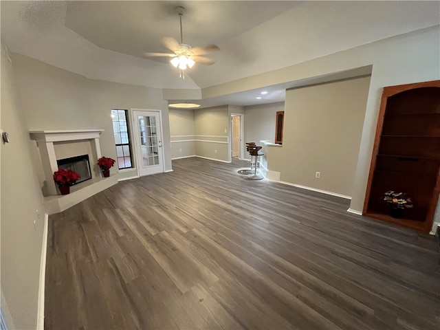 unfurnished living room featuring dark hardwood / wood-style floors and ceiling fan