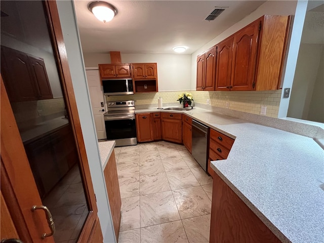 kitchen featuring decorative backsplash, sink, and appliances with stainless steel finishes