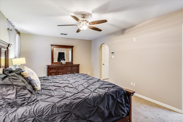 14970 Topgallant St, Corpus Christi, TX 78418 - bedroom with arched walkways, light carpet, baseboards, and ceiling fan
