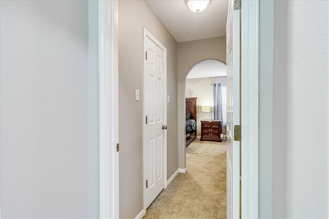 14970 Topgallant St, Corpus Christi, TX 78418 - corridor featuring light colored carpet, arched walkways, and baseboards