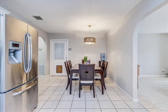 14970 Topgallant St, Corpus Christi, TX 78418 - dining area featuring arched walkways, light tile patterned floors, and a chandelier