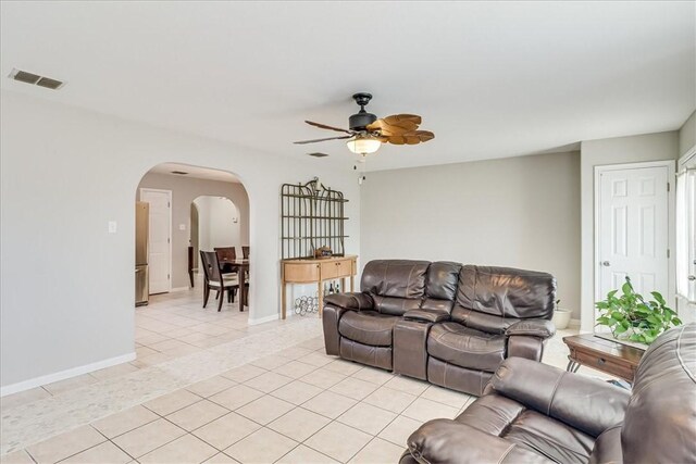 14970 Topgallant St, Corpus Christi, TX 78418 - living area with arched walkways, ceiling fan, light tile patterned floors, and baseboards