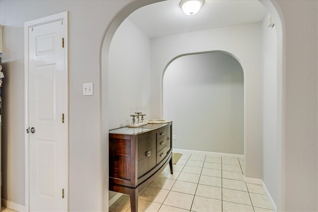 14970 Topgallant St, Corpus Christi, TX 78418 - hall featuring arched walkways, light tile patterned floors, a sink, and baseboards