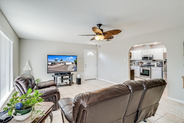 14970 Topgallant St, Corpus Christi, TX 78418 - living area featuring light tile patterned floors, arched walkways, a ceiling fan, and baseboards