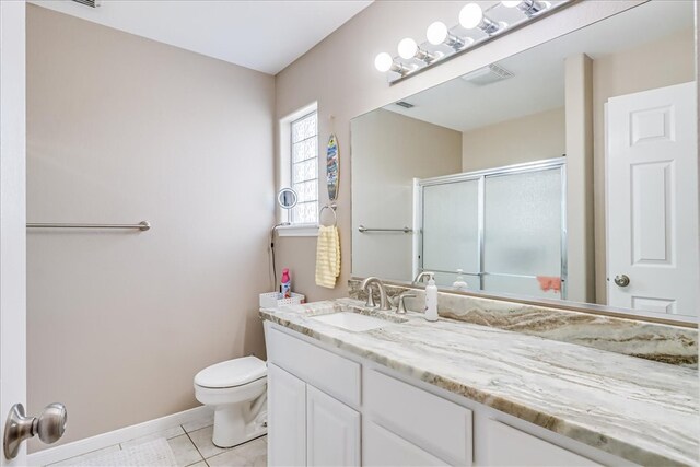 14970 Topgallant St, Corpus Christi, TX 78418 - bathroom featuring vanity, tile patterned floors, a stall shower, toilet, and baseboards