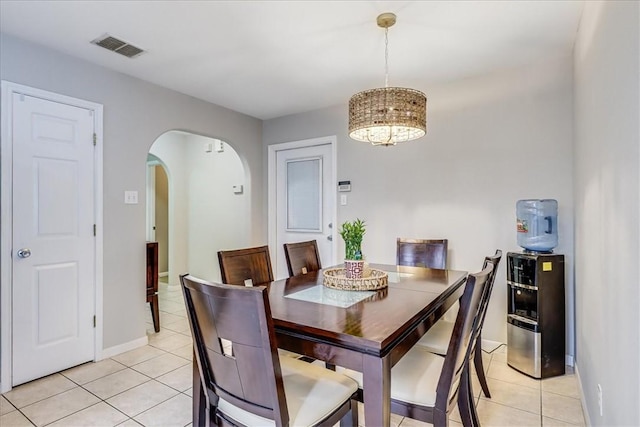 14970 Topgallant St, Corpus Christi, TX 78418 - dining area with light tile patterned floors, arched walkways, and baseboards