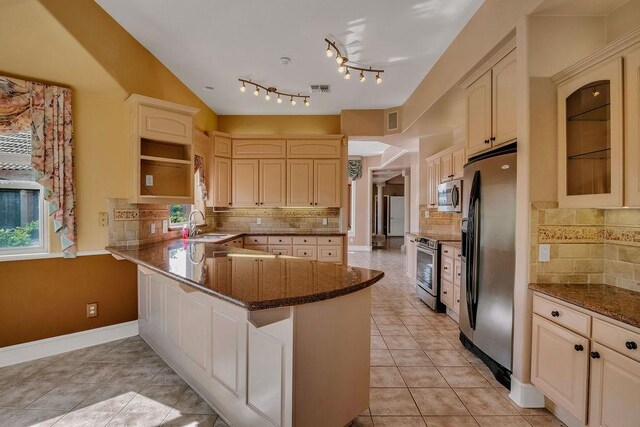 4950 Deer Park, Corpus Christi, TX 78413 - kitchen featuring appliances with stainless steel finishes, a peninsula, decorative backsplash, open shelves, and dark stone counters