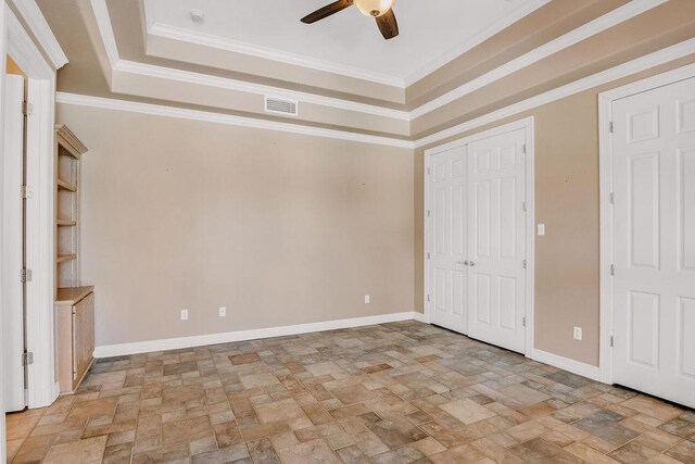 4950 Deer Park, Corpus Christi, TX 78413 - unfurnished bedroom with stone finish floors, ornamental molding, a raised ceiling, a ceiling fan, and a closet