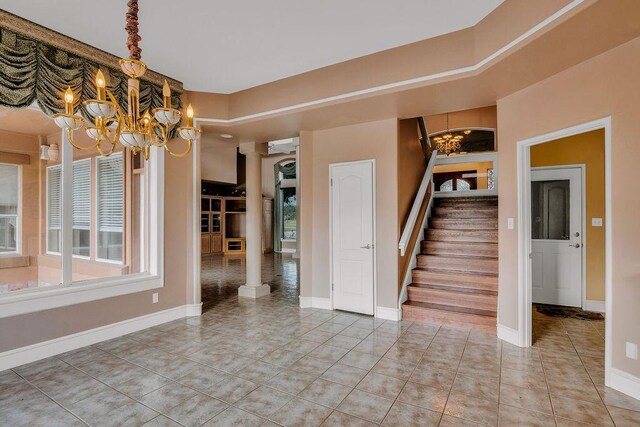 4950 Deer Park, Corpus Christi, TX 78413 - spare room with a chandelier, stairs, plenty of natural light, and ornate columns