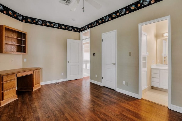 4950 Deer Park, Corpus Christi, TX 78413 - unfurnished bedroom featuring dark wood-style floors, an office area, and ensuite bath