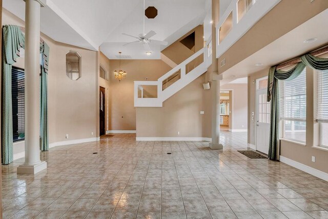 4950 Deer Park, Corpus Christi, TX 78413 - unfurnished living room with decorative columns, ceiling fan, high vaulted ceiling, and tile patterned flooring