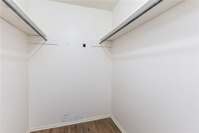walk in closet with visible vents and wood finished floors