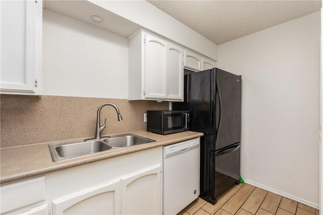 kitchen featuring white cabinetry, dishwasher, light countertops, and a sink