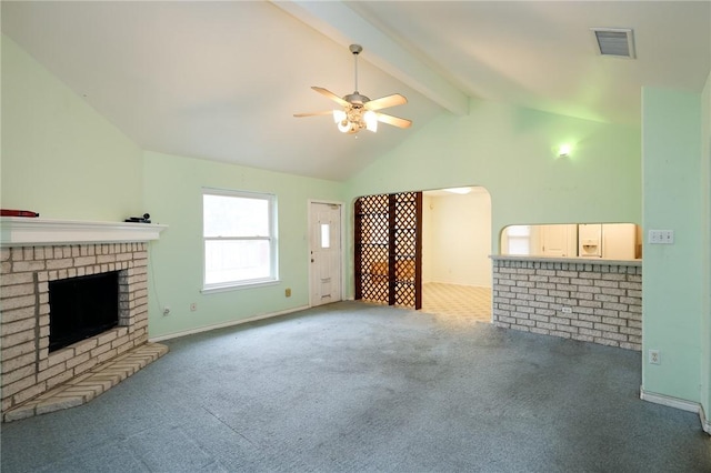 unfurnished living room with high vaulted ceiling, a fireplace, beamed ceiling, carpet, and ceiling fan