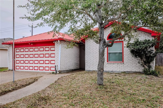 view of front of house with a garage and a front lawn