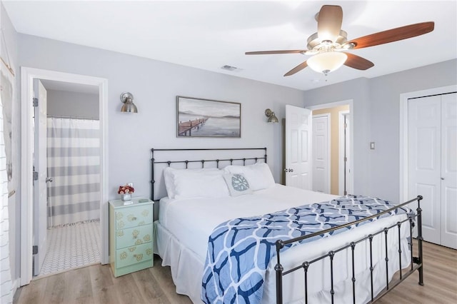 bedroom featuring visible vents, a closet, light wood-style flooring, and a ceiling fan