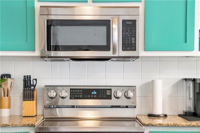 2120 S 11th St Unit 404, Port Aransas, TX 78373 - kitchen view of stainless steel appliances, tasteful backsplash, light stone counters, and mail area