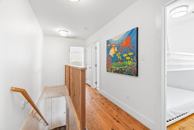 2120 S 11th St Unit 404, Port Aransas, TX 78373 - hall with light wood finished floors, baseboards, and an upstairs landing
