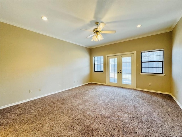 spare room with ornamental molding, french doors, ceiling fan, and carpet