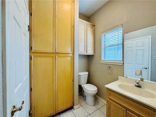 bathroom featuring tile patterned flooring, vanity, and toilet