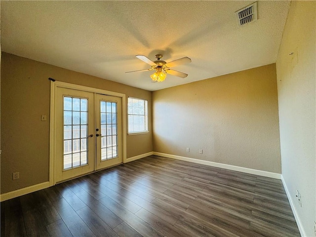 spare room with french doors, ceiling fan, dark hardwood / wood-style floors, and a textured ceiling