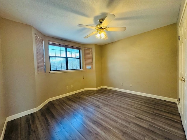 empty room featuring dark wood-type flooring, ceiling fan, and a textured ceiling