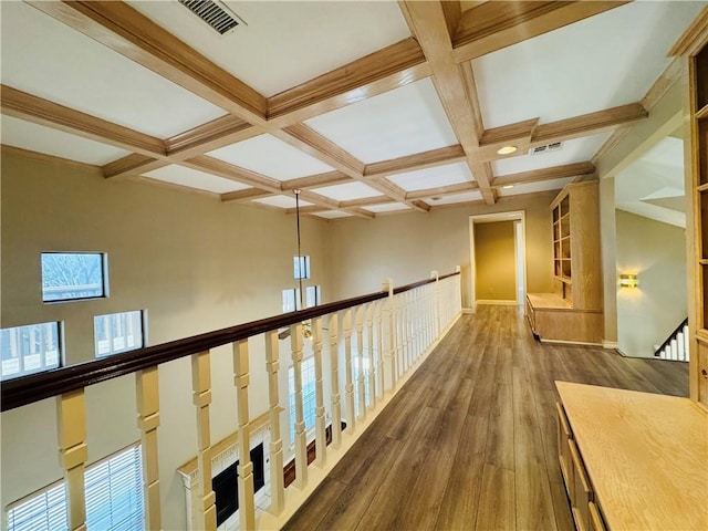 hall featuring beamed ceiling, coffered ceiling, and dark hardwood / wood-style flooring