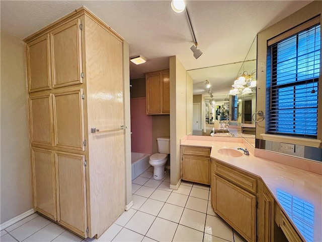 6242 Strasbourg Dr, Corpus Christi, TX 78414 - bathroom with track lighting, tile patterned floors, toilet, baseboards, and a textured ceiling