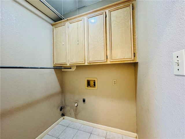 laundry area featuring light tile patterned flooring, cabinets, hookup for a washing machine, hookup for an electric dryer, and hookup for a gas dryer