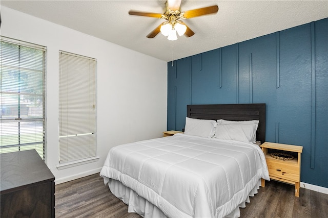 bedroom featuring ceiling fan, a textured ceiling, and dark hardwood / wood-style flooring