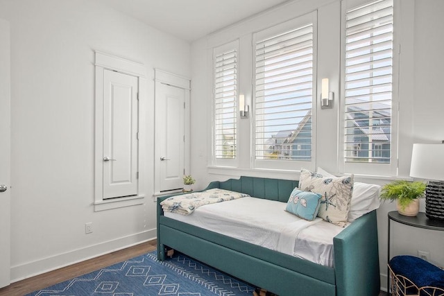 bedroom featuring baseboards and wood finished floors