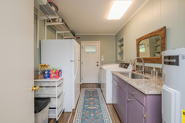 161 Red Bird Rdg, Beeville, TX 78102 - laundry area featuring dark wood-style flooring, crown molding, water heater, and washing machine and clothes dryer