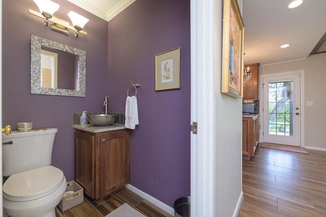 161 Red Bird Rdg, Beeville, TX 78102 - bathroom with crown molding, vanity, wood finished floors, baseboards, and toilet