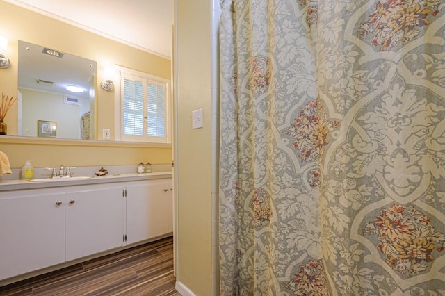 161 Red Bird Rdg, Beeville, TX 78102 - bathroom with vanity, ornamental molding, and wood finished floors