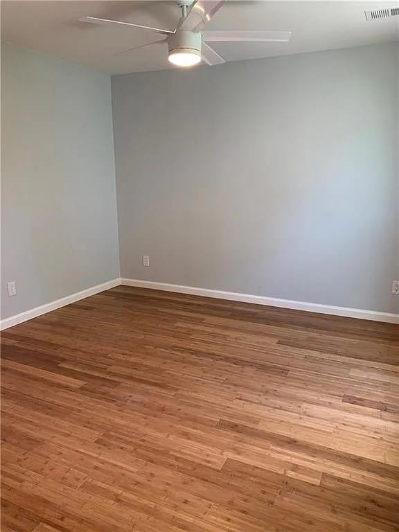 spare room with light hardwood / wood-style flooring and ceiling fan