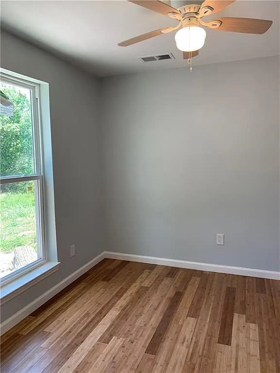 spare room with light hardwood / wood-style flooring and ceiling fan