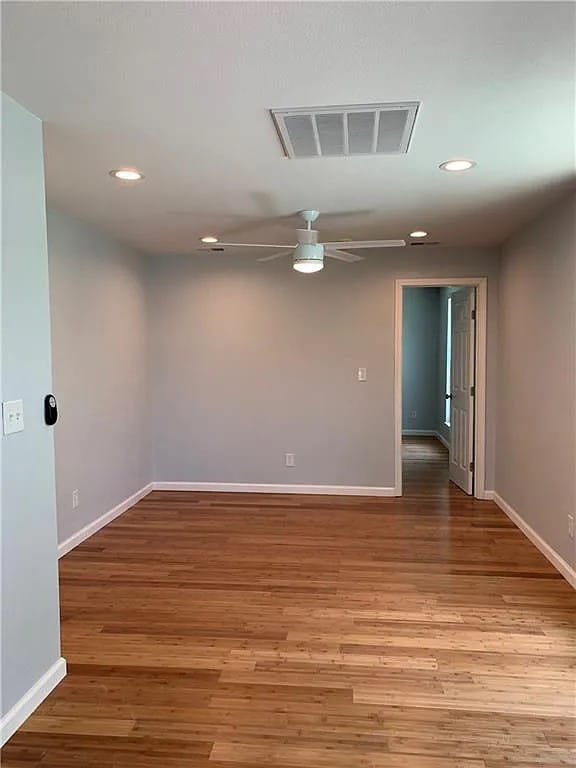 unfurnished room with ceiling fan and light hardwood / wood-style flooring