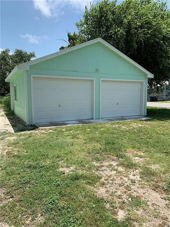 garage featuring a lawn