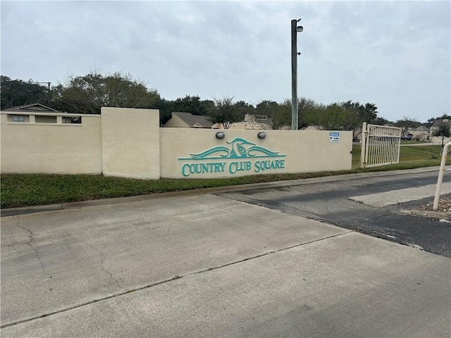 community / neighborhood sign with fence