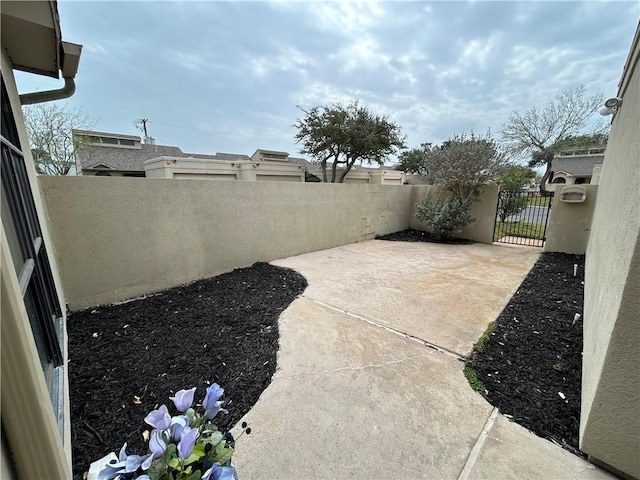 view of patio featuring a fenced backyard and a gate