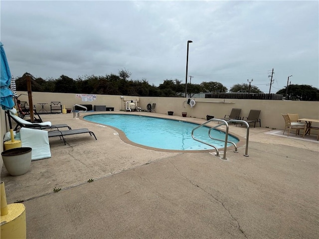 pool featuring a patio and fence