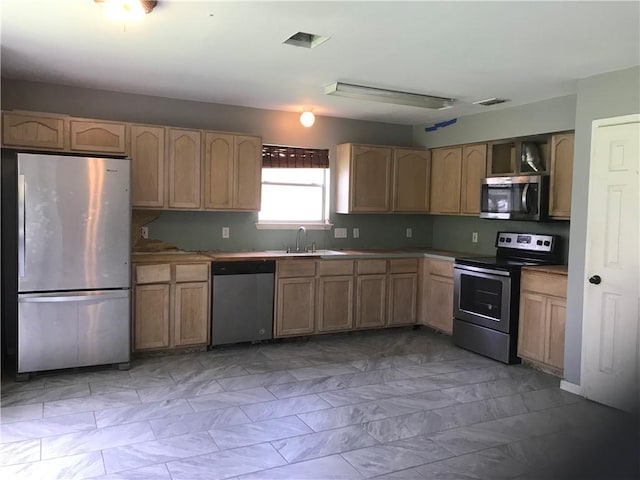 5026 Graford Pl, Corpus Christi, TX 78413 - kitchen featuring stainless steel appliances, light brown cabinetry, and light marble finish floors