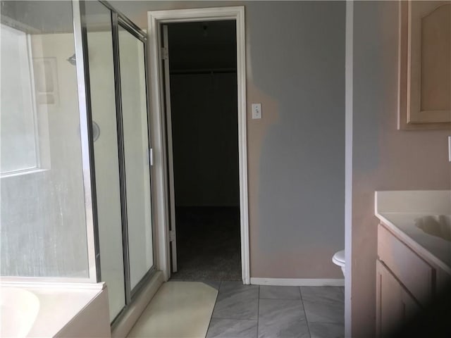 5026 Graford Pl, Corpus Christi, TX 78413 - full bathroom featuring vanity, a shower stall, a walk in closet, and a bathtub
