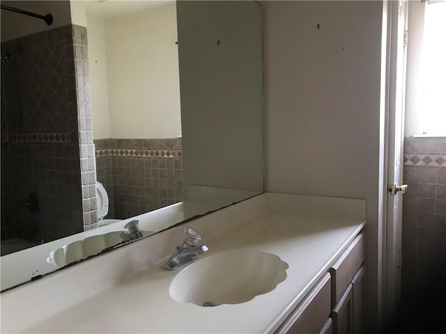 5026 Graford Pl, Corpus Christi, TX 78413 - bathroom featuring tile walls, vanity, wainscoting, and  shower combination
