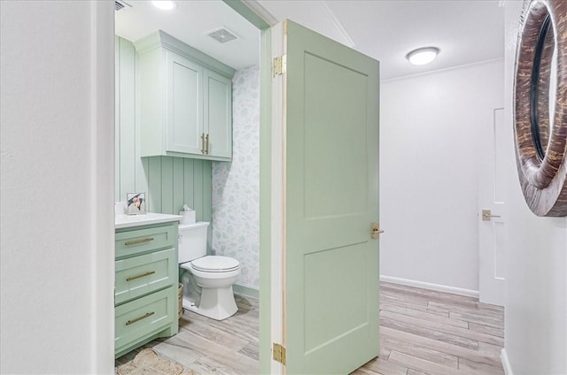 bathroom featuring hardwood / wood-style flooring, toilet, and vanity