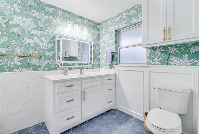 bathroom with toilet, tile patterned flooring, and vanity