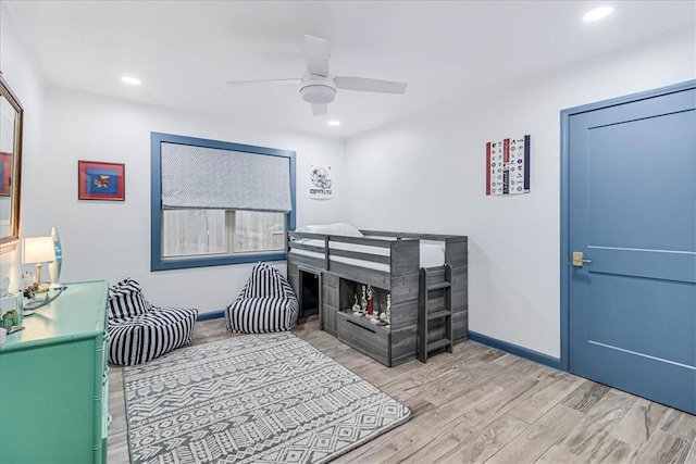 bedroom with ceiling fan and light hardwood / wood-style flooring