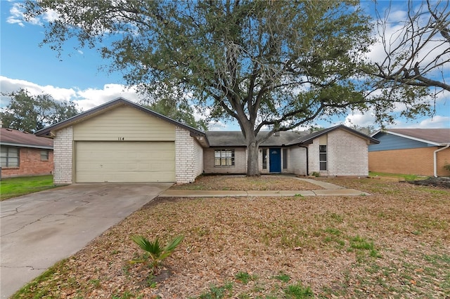 view of front of property with an attached garage, driveway, and brick siding